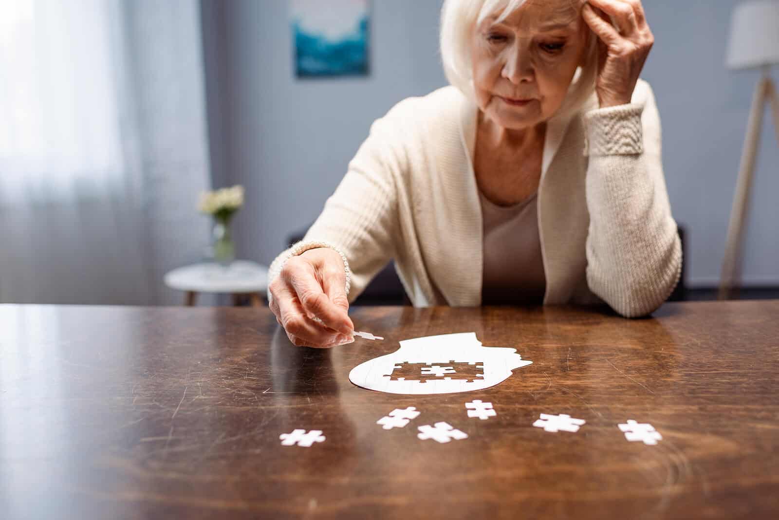Elderly Woman putting together head puzzle